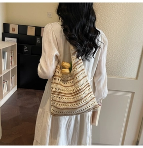 Detail of hollow-out crochet tote bag with striped texture and spacious interior