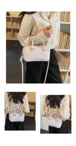 Detail of lavender patent leather handbag with dual handles and logo embossing