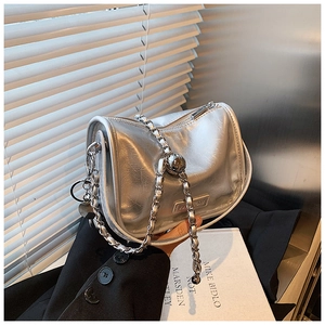 Detail of silver metallic handbag with wrinkled texture and fashion metal logo lettering