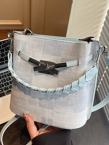 Blue and white checkered bucket bag with interlocking metal buckle and woven handle
