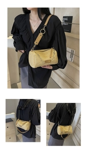 Macro detail of ginger woven cylinder bag with gold chain and leather strap