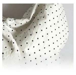 Detail showing the soft drape of large capacity polka dot canvas tote with fabric pleats