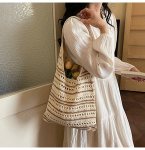 Detail of hand-woven bucket bag featuring a beige and coffee striped hollow pattern