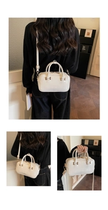 Detail view of the ROSY DODENIA white leather small square bag with golden hardware