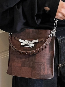 Retro dark brown bucket bag with a textured finish and stylish silver twist-lock closure