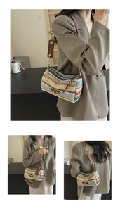 Close-up of woven cylinder bag featuring colorful stripes and stylish metal chain