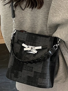 Classic checkered bucket bag with leather strap and silver twist lock in minimalist style