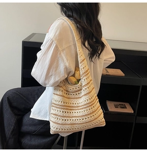 Detail of hand-woven crochet shoulder bag with beige and brown stripes and hollow texture