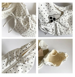 Detailed views of polka dot canvas bag with drawstring sides and ring zipper pull