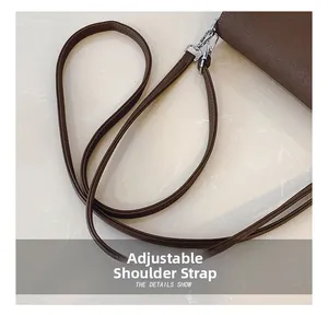 Detail of adjustable dark brown litchi leather strap with silver metal swivel hook