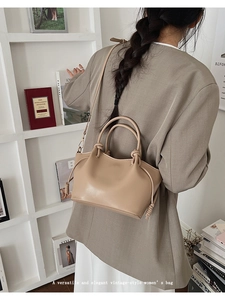 Detailed view of the khaki bucket bag with knot detail shown on a model