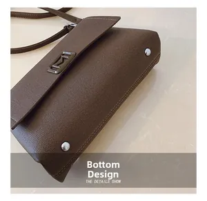 Detail view of dark brown leather handbag with silver bottom studs for protection