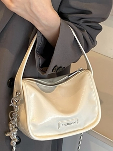 Minimalist beige patent leather square handbag with silver chain and top handle