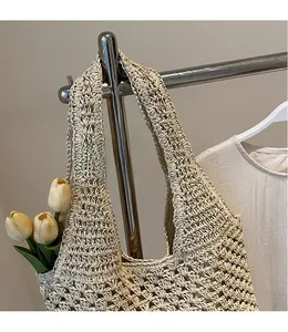 Detail of off-white hand-crocheted shoulder bag with hollow texture and natural weave