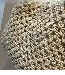 Detailed close-up showing the intricate woven texture and inner lining of the straw bag