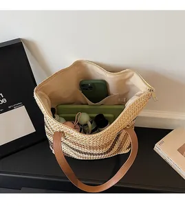 Interior view of large woven beach bag showing spacious lining and leather handles