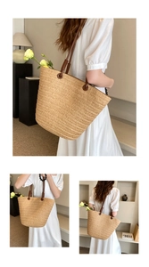 Detail view of large straw tote bag with brown straps and fine woven texture in home setting