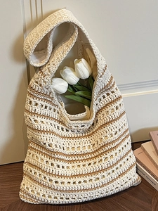 Elegant woven straw bucket bag with brown stripes and white tulip for casual styling
