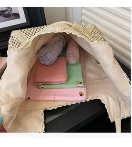 Spacious interior of beige straw tote bag showing storage for umbrella and tablet