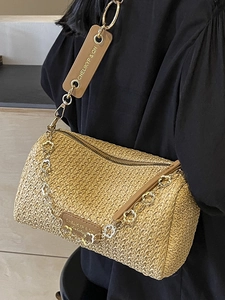 Chic cylindrical straw crossbody bag with golden flower chain and brown leather strap