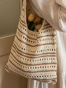 Woven straw bucket bag with brown stripes and hollow design for casual shoulder carry