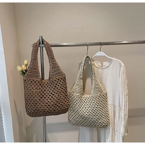 Detailed close-up of handmade woven straw tote bags in coffee and cream with mesh pattern