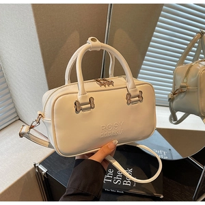 Detail showing the white leather texture, embossed logo, and elegant gold metal hardware
