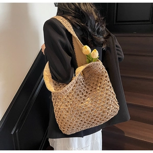 Detail of hand-woven straw tote bag with mesh hollow texture and fabric lining