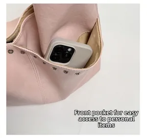 Detailaufnahme einer rosa Lederhandtasche mit praktischer Vordertasche für ein Smartphone