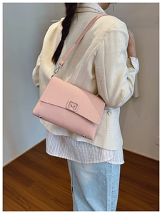 Close-up of pink shoulder bag with M letter buckle and model showing wearing effect