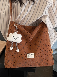 Brown corduroy tote bag with heart patterns and a cute plush cloud charm