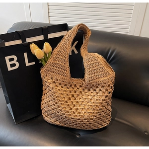 Detailed macro view of handcrafted hollow woven straw bag with textured grass material