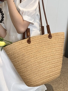 French style straw woven tote bag with brown leather handles for summer beach use