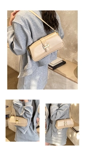Detail view of cream underarm bag with golden buckle hardware and adjustable strap