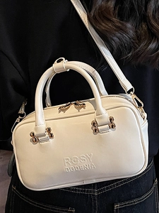 White minimalist square handbag with top handles and adjustable strap for daily commute