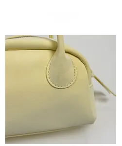 Close-up of premium cream leather bowling bag showing meticulous stitching and zip detail