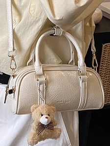 Chic white Boston handbag in lychee grain leather with plush bear charm for women