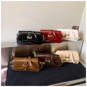 Detailed row of various colored leather crossbody bags with iconic gold H-shaped buckles