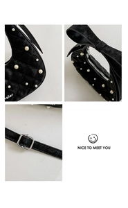 Detailed views of black velvet bag with pearls, ribbon bow handle and forever embroidery