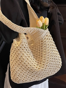 Chic hollow-out straw tote bag in off-white crochet finish for seaside beach vacations
