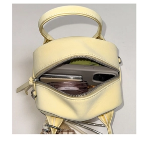 Top macro view of yellow mini bowling bag showing inner storage space for phone and makeup