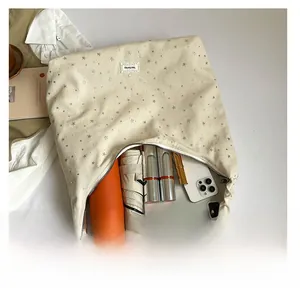 Internal view showing large capacity for tablet and daily items in beige canvas tote bag