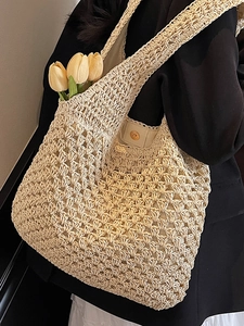 Chic woven straw tote bag for beach vacations with hollow crochet texture and magnetic closure