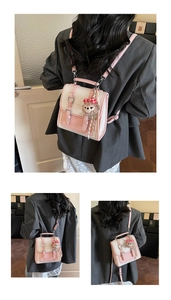 Detailed view of bicolor pink and white mini bag with ShellieMay plush charm and ribbon