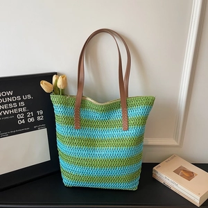 Détail du sac cabas rayé tissé à la main avec motifs vert et bleu et anses en similicuir marron