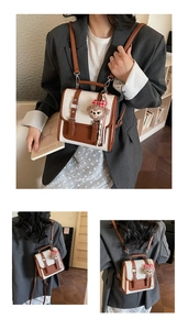 Detail of a retro two-tone mini backpack with premium lychee grain PU leather texture