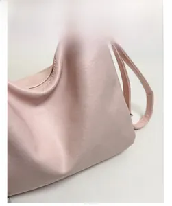 Detail view of pink soft leather texture with Fashion lettering on the handbag