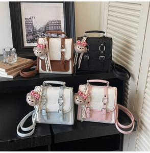 Detail view of retro square shoulder bags in four colors with textured PU leather finish