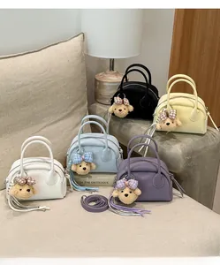 Detail of macaron color bowling bags with cute plush puppy charms in studio setting