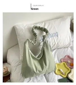 Detail of light green canvas tote bag with silver star prints and pleated cloud handle
